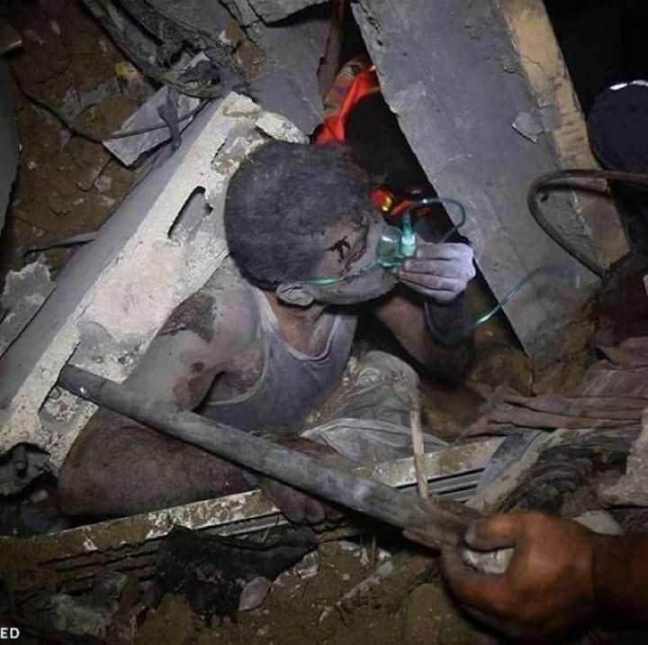مشهد مؤثر.. مواطن يداعب وجه طفله الوحيد الناجي من مجزرة إسرائيلية بغزة